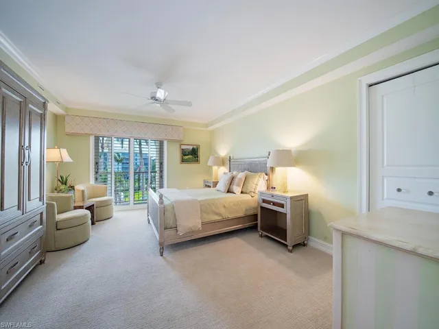 Guest bedroom with Eastern balcony and multiple closets, floor safe