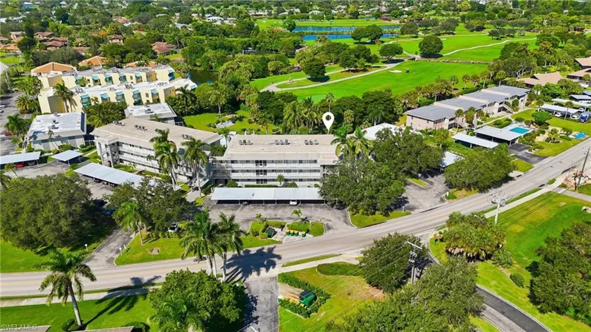 Aerial overview of property's location with a large body of water and a local golf course