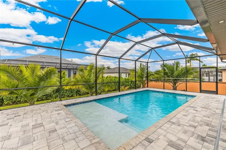 Outdoor pool featuring a sunroom, a lanai, and a patio