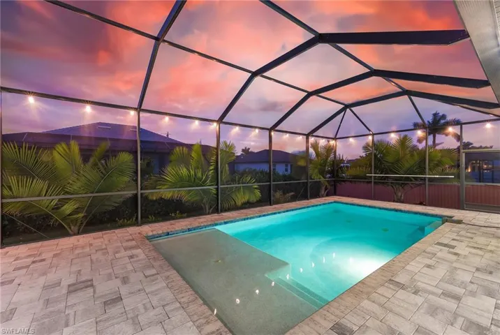Swimming pool featuring a lanai and a sunroom