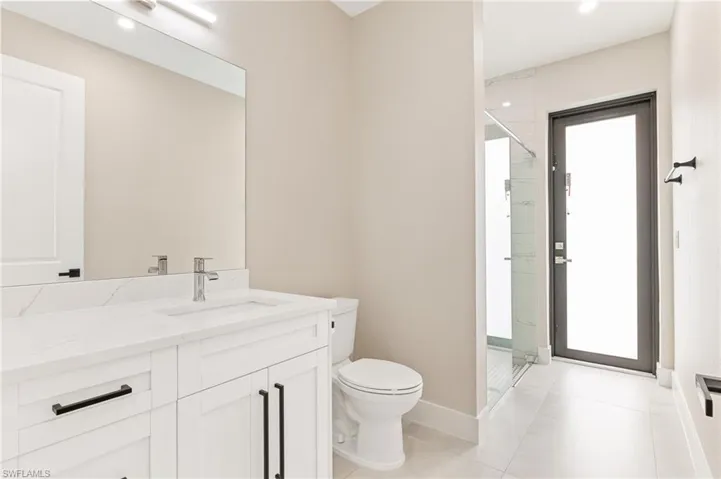Full bathroom with vanity, a shower stall, and light tile patterned flooring