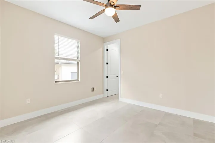 Spare room with baseboards and a ceiling fan