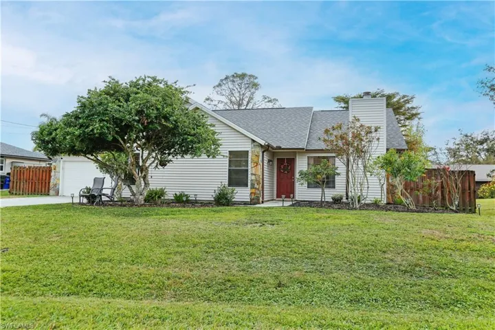 Ranch-style home with a garage and a front yard