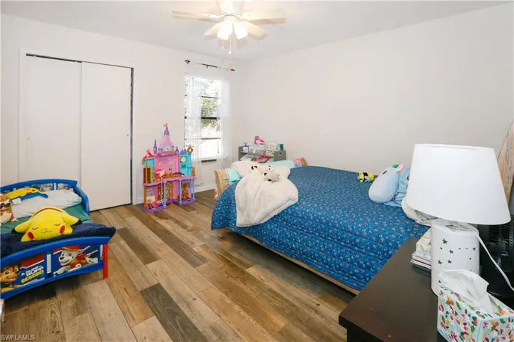Bedroom featuring hardwood / wood-style floors, a closet, and ceiling fan