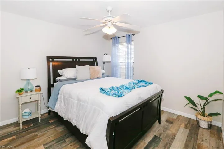 Bedroom featuring dark wood-type flooring and ceiling fan