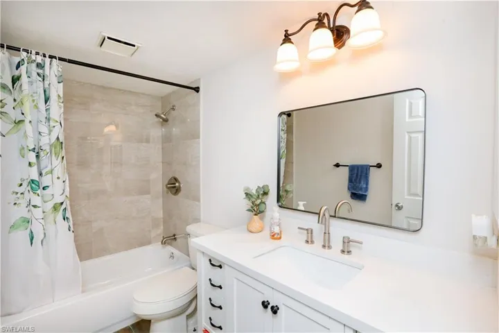 Full bathroom featuring vanity, toilet, and shower / bath combo with shower curtain