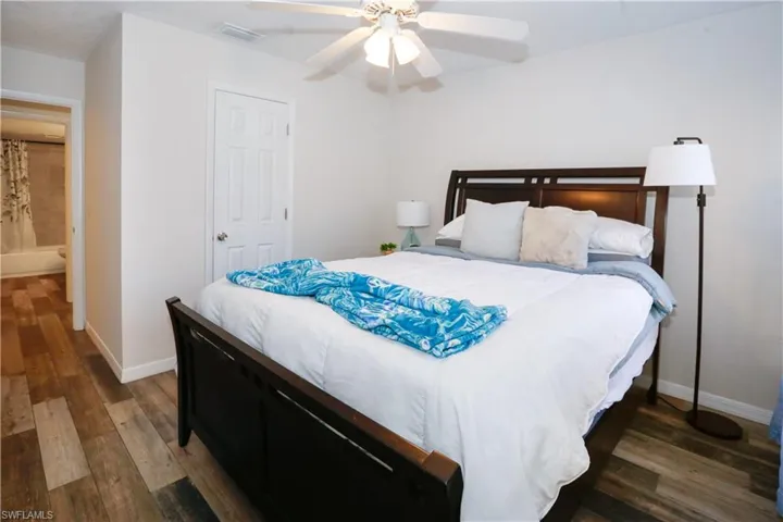 Bedroom featuring dark hardwood / wood-style floors and ceiling fan