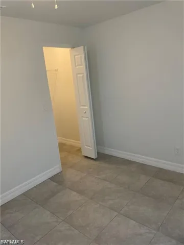 Unfurnished room featuring baseboards