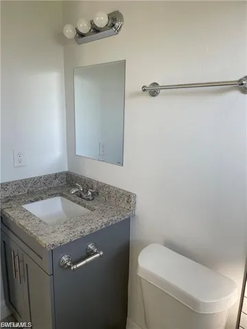 Half bathroom with vanity and toilet