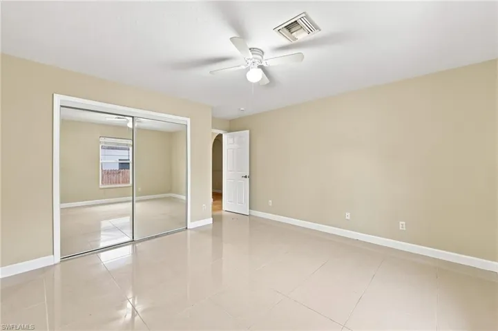 Bedroom featuring expansive mirrored closet doors