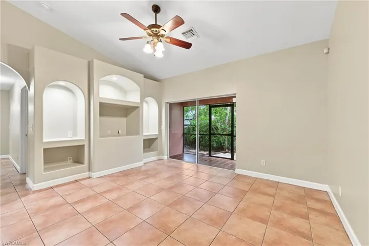 Spacious secondary living area featuring terracotta tile flooring, recessed lighting, and a ceiling fan with integrated light fixture
