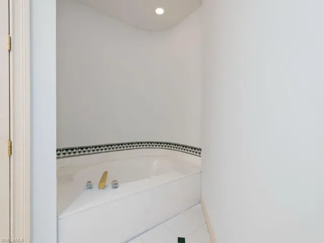 Bathroom with a garden tub, tile patterned flooring, and recessed lighting