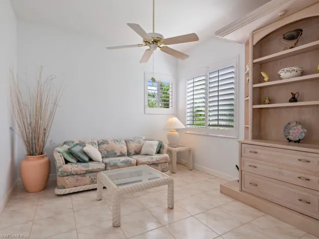 Living room with ceiling fan and light tile patterned floors