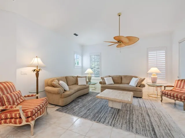 Living area featuring tile patterned flooring and ceiling fan