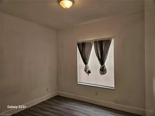 Spare room with wood-type flooring