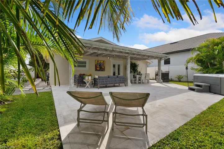 View of patio featuring an outdoor hangout area, a hot tub, french doors, and outdoor dining space