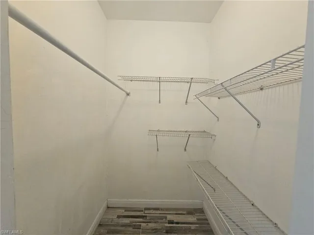 Walk in closet featuring hardwood / wood-style flooring