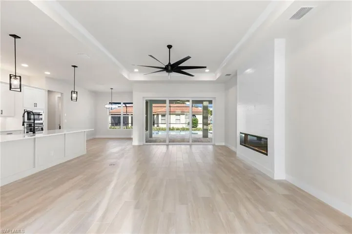 Overall view of living room, dining room, pool and kitchen