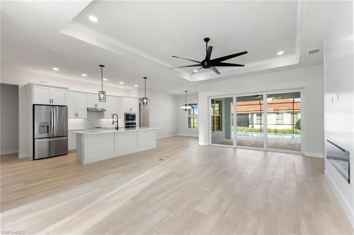 Beautiful Great Room showcasing the kitchen and dining area and media wall