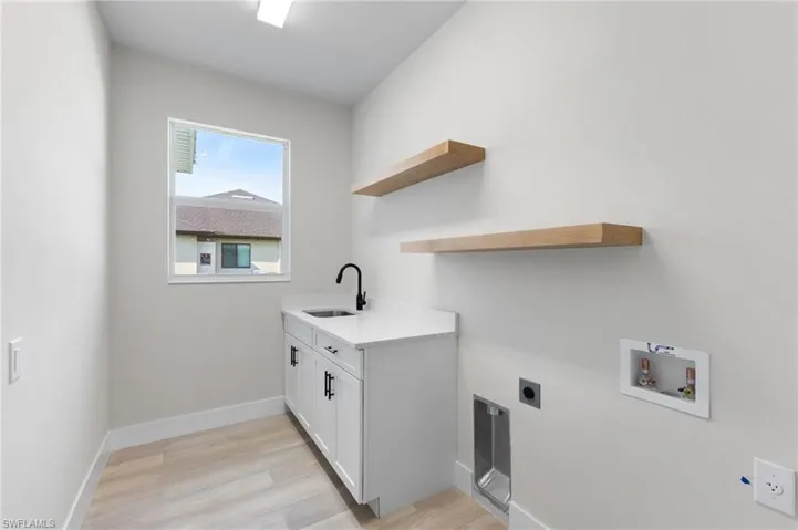 Perfect size laundry room with tub and quartz counter and floating shelves to make your laundry room Instagram ready!