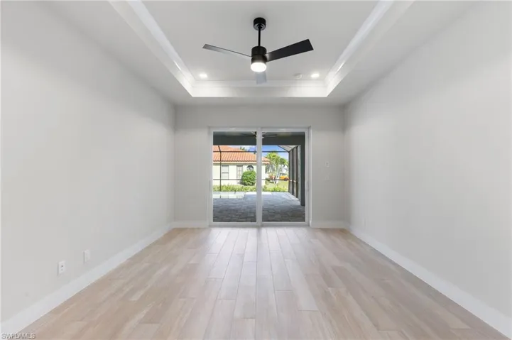 Leads out to the paved lanai and pool area