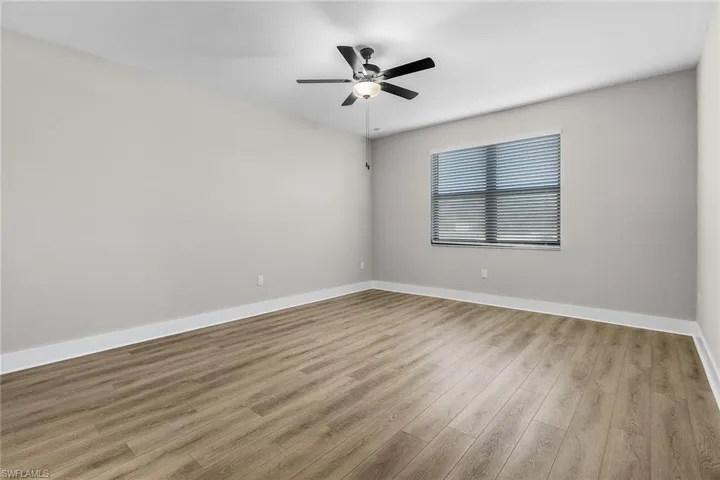Empty room featuring light wood-style flooring and ceiling fan