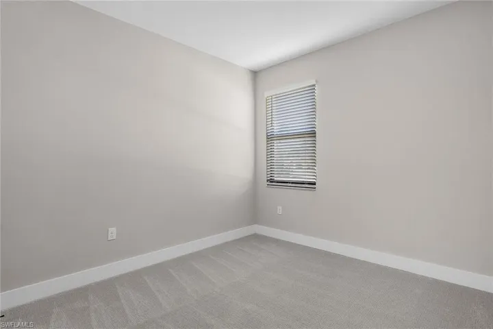 Unfurnished room with baseboards and carpet flooring