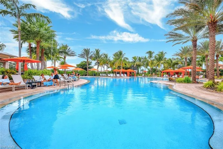 Beautiful resort pool with palms and cabanas.
