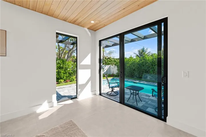 Doorway with wood ceiling and baseboards