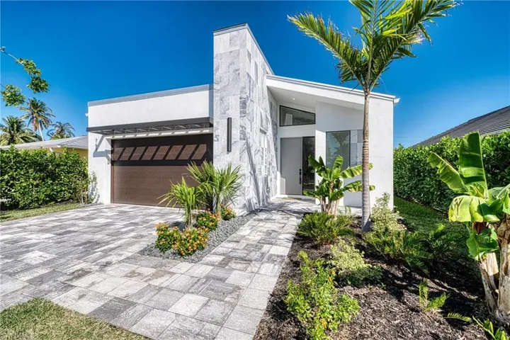 View of front of home featuring decorative driveway and stucco siding
