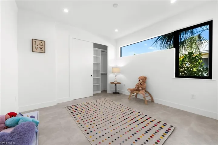 Sitting room featuring baseboards, concrete floors, and recessed lighting
