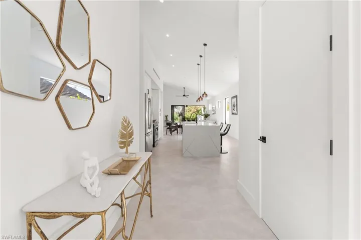 Hall with recessed lighting and a high ceiling