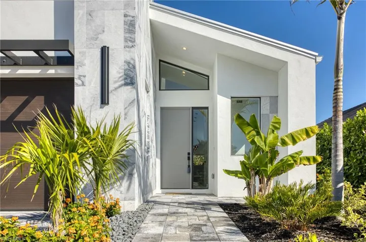 Doorway to property featuring stucco siding