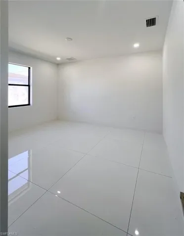 Empty room with light tile patterned floors