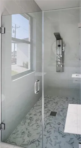Bathroom with walk in shower and tile patterned floors