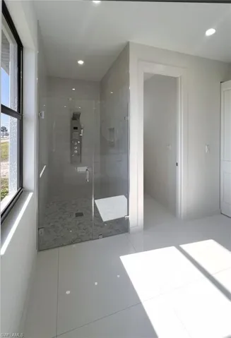 Bathroom featuring tile patterned flooring and walk in shower