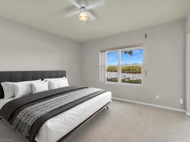 This photo includes reality staging to show the potential of the primary bedroom.