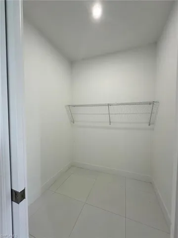 Spacious closet featuring tile floors