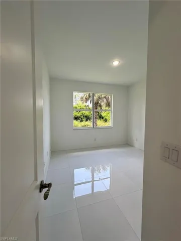 Empty room with light tile floors
