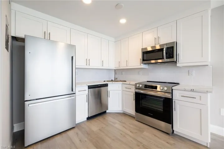 Beautifully remodeled kitchen with quartz countertops and stainless steel appliances
