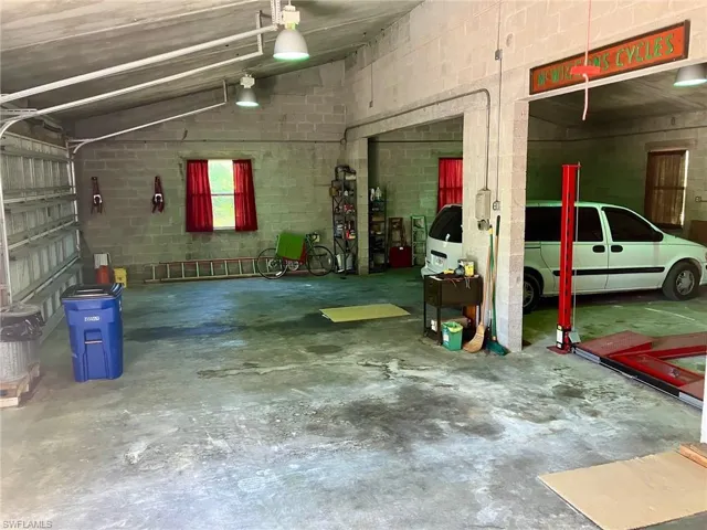The far section of the garage can easily hold 4 cars.  Double bay garage door for this section.