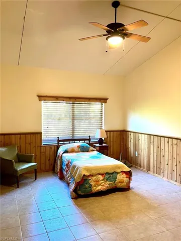 The guest bedroom is also huge with high ceilings, pine wainscot and tile floors.  It includes another large closet that could get even bigger.  This room would easily accommodate two queen beds or work as a bunk room.