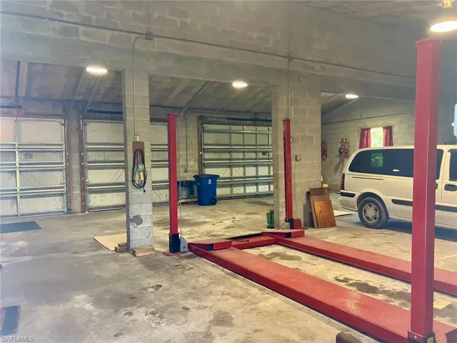 Garage can easily hold a multitude of things. Auto lift included with sale.
