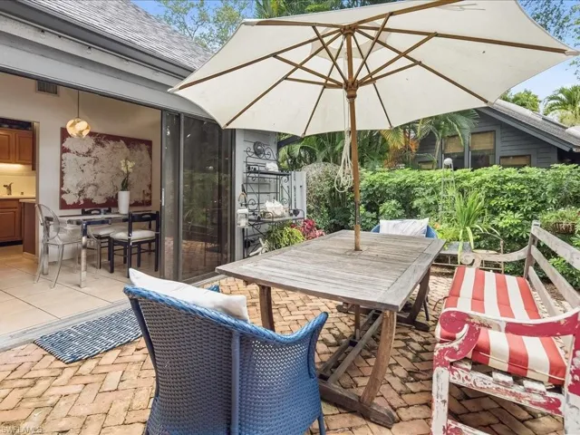 Brick paver patio featuring lush perimeter landscaping