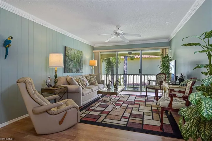 Spacious, comfortable living area with plenty of seating, natural light and direct access to the private balcony.