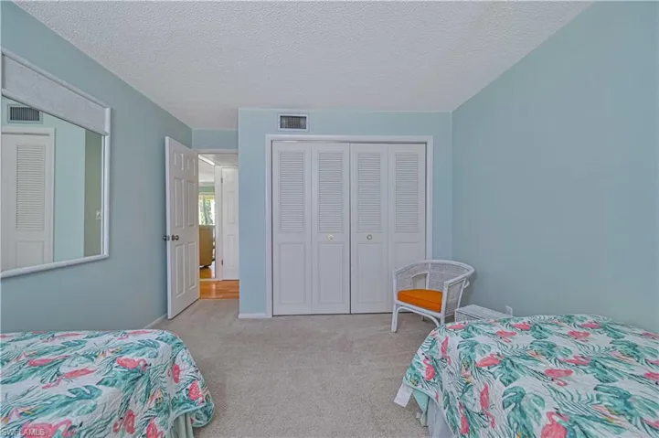 Another view highlights the generous size of the guest bedroom, with a large double closet offering plenty of storage for guests or seasonal stays.