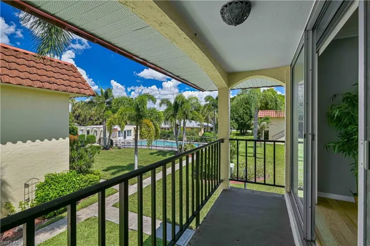Step out onto your private balcony and enjoy peaceful views of the tropical courtyard and community pool—the perfect spot for morning coffee or an evening cocktail.