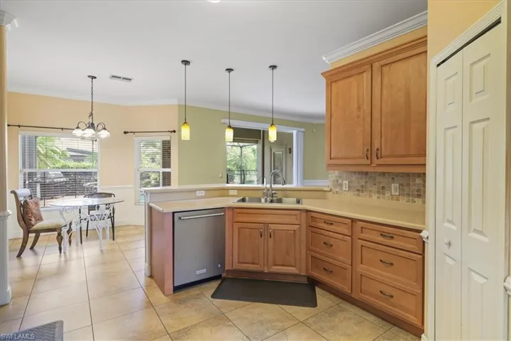 View of pool with a sunroom, glass enclosure, a patio area, and area for grilling