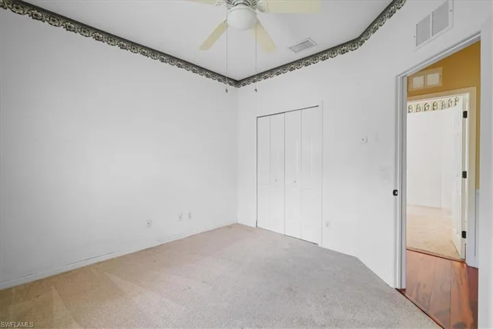 Entryway featuring wood finished floors, ornamental molding, and arched walkways