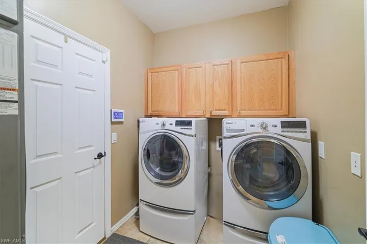 Kitchen featuring crown molding, ceiling fan, a chandelier, and light tile patterned flooring